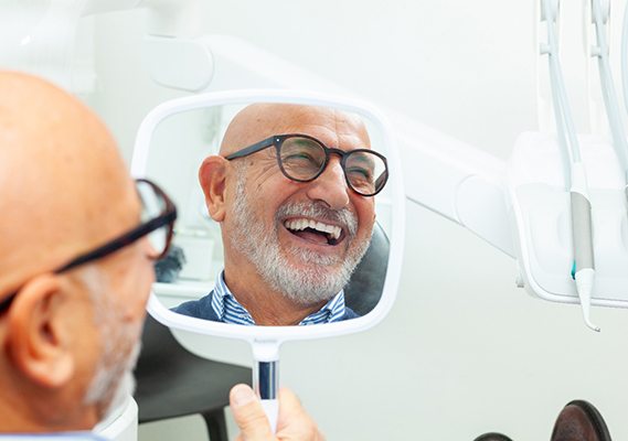 A man smiling in a mirror
