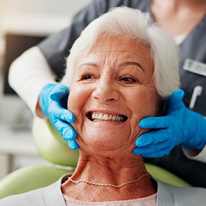 A woman smiling after dental implant surgery