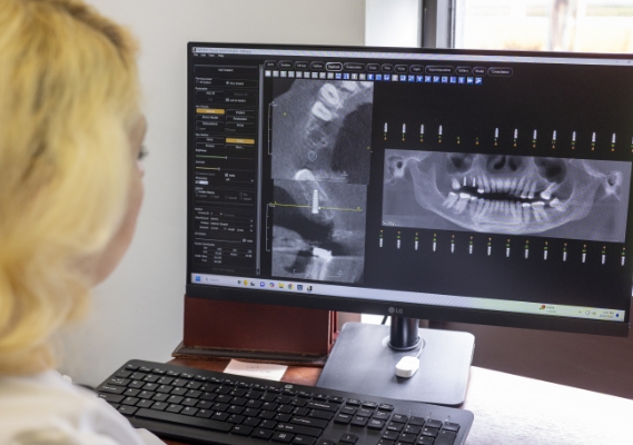 Looking at dental X-rays on computer monitor