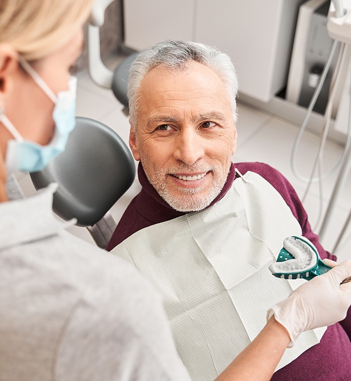 Dentist in Springfield reviewing denture candidacy with a patient