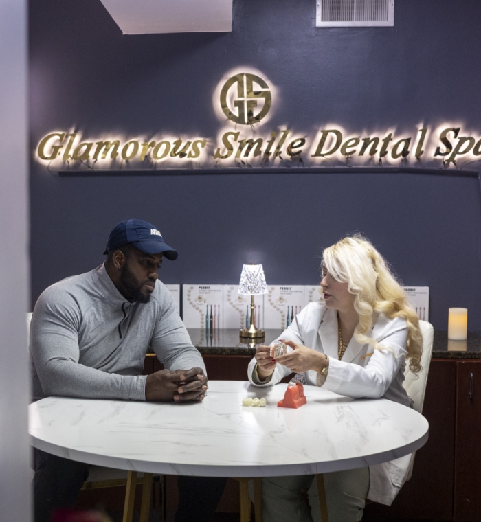 Dentist and patient speaking in waiting room