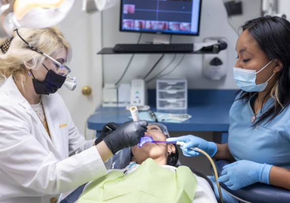 Dentists with masks treating a patient