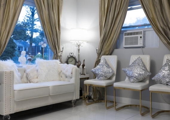 Couch with fluffy pillows and chairs with sparkly pillows