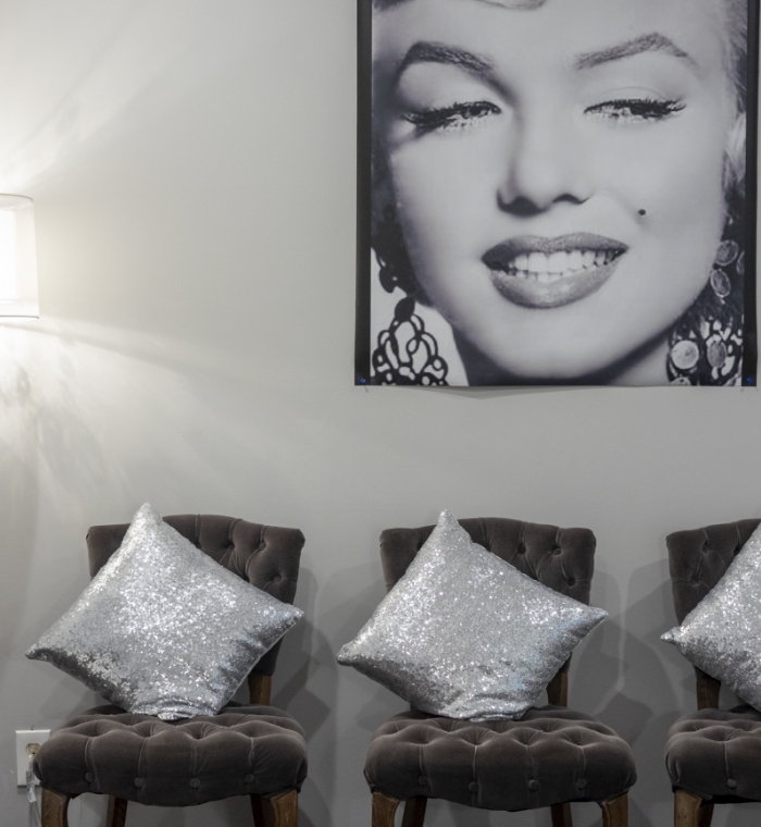 Chairs in dental waiting area with sparkly pillows on chairs