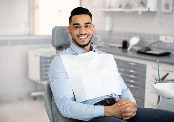 Patient smiling while sitting in treatment chair