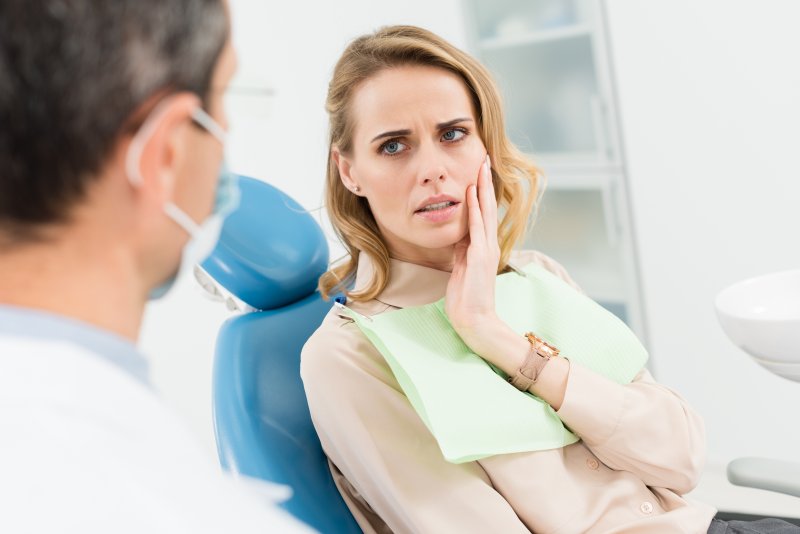 Patient with dental emergencies looking concerned at dentist